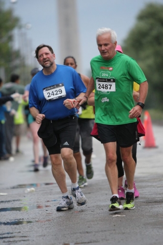 A volunteer and athlete running together